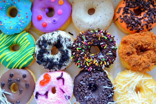 Free A vibrant selection of decorated donuts with various toppings, perfect for festive occasions. Stock Photo