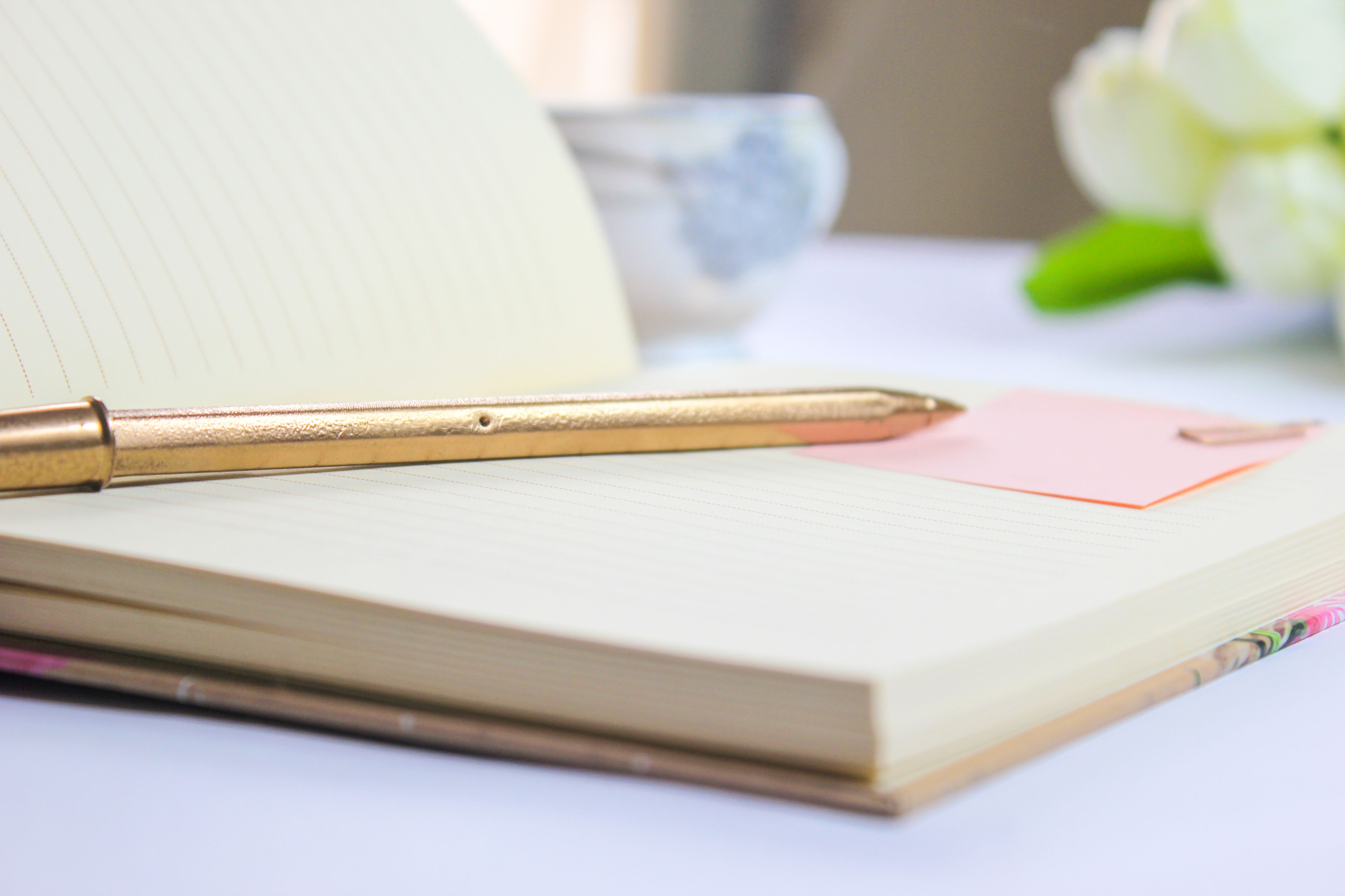 Carnet elegant et stylo dore pour illustrer la preparation d un mariage haut de gamme