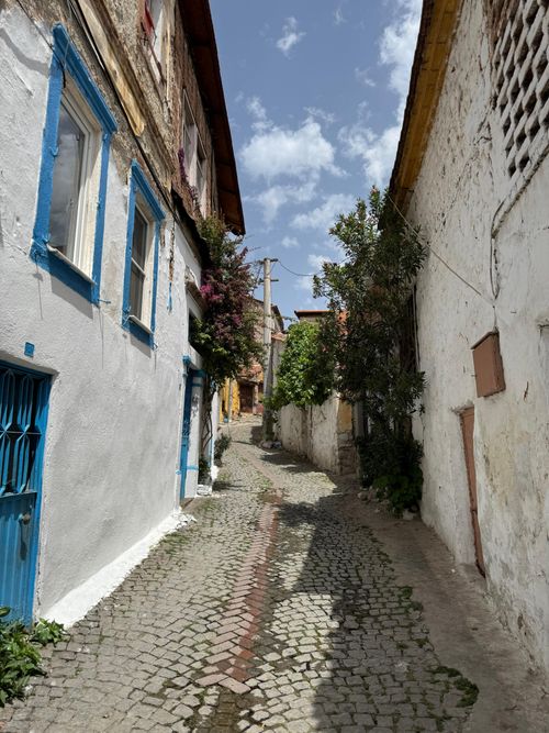 Free Quaint cobblestone street in Bergama, İzmir, Türkiye, featuring colorful historic architecture. Stock Photo
