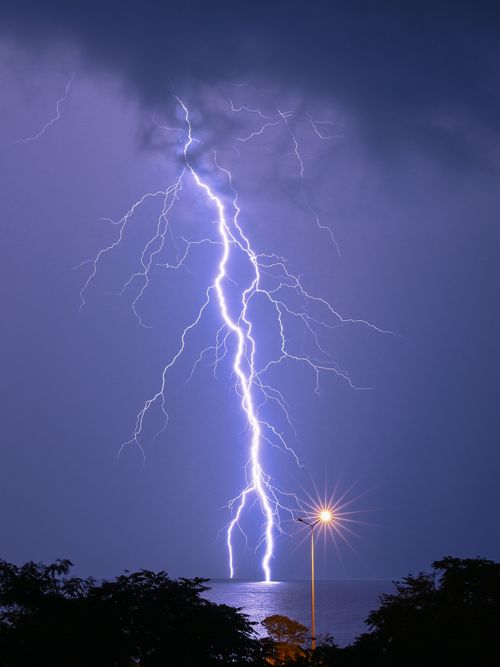 Free Dramatic lightning bolt illuminates the sky over a tranquil sea in Fındıklı, Rize, Türkiye. Stock Photo