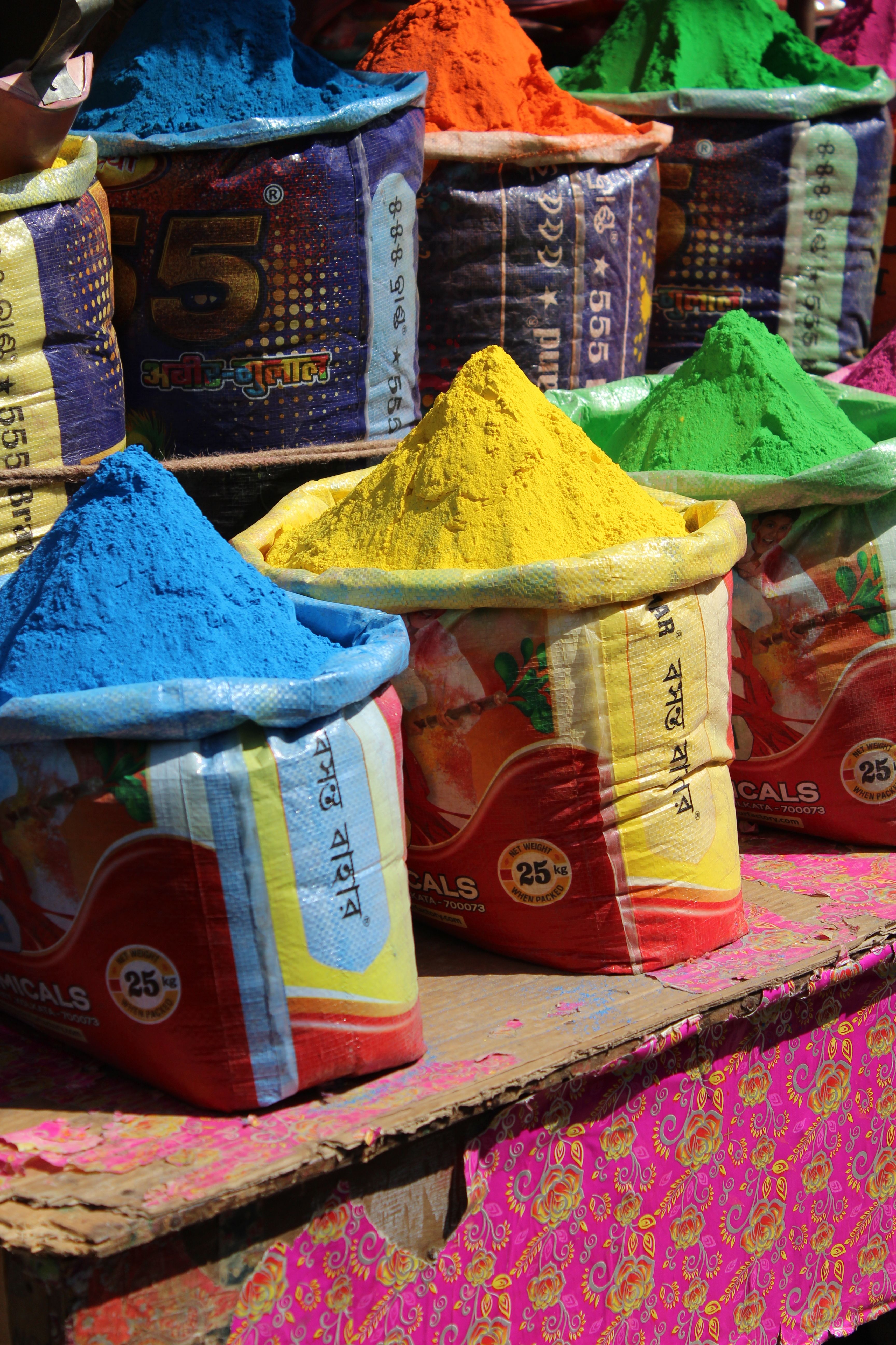 Vibrant Holi Powder Display in Market Stall · Free Stock Photo