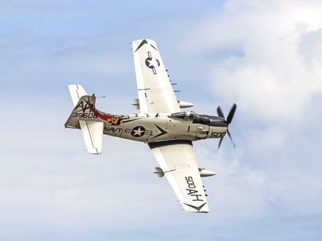 US Navy A-1 Skyraider aircraft soaring above Titusville, captured in dynamic flight.