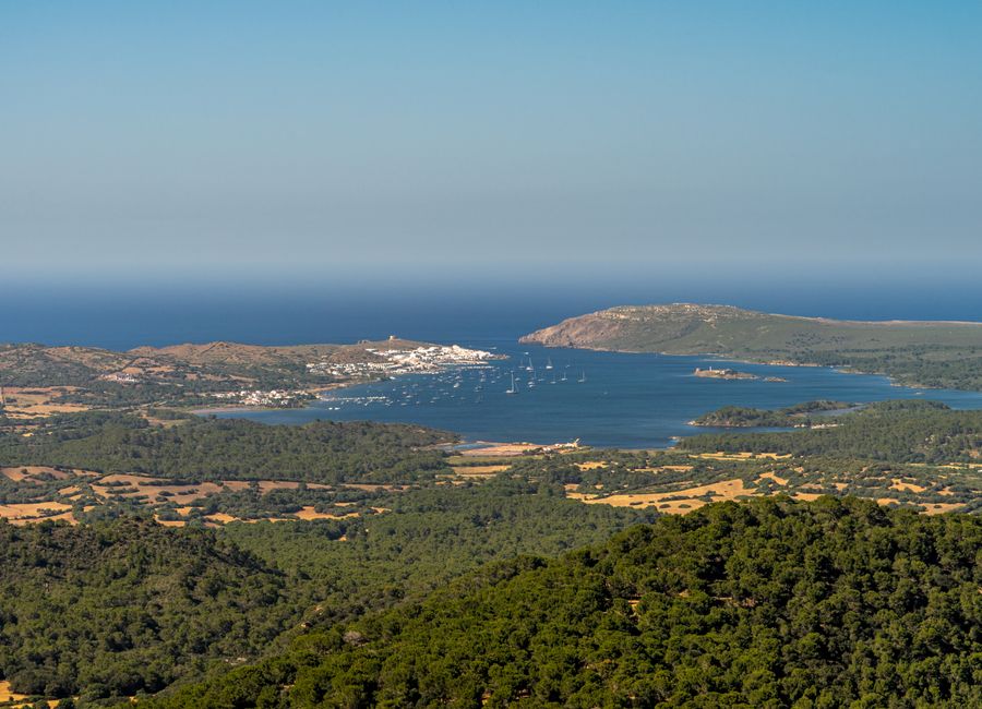 Breathtaking aerial view of Ciutadella, Islas Baleares, showcasing the Mediterranean Sea and lush landscapes.