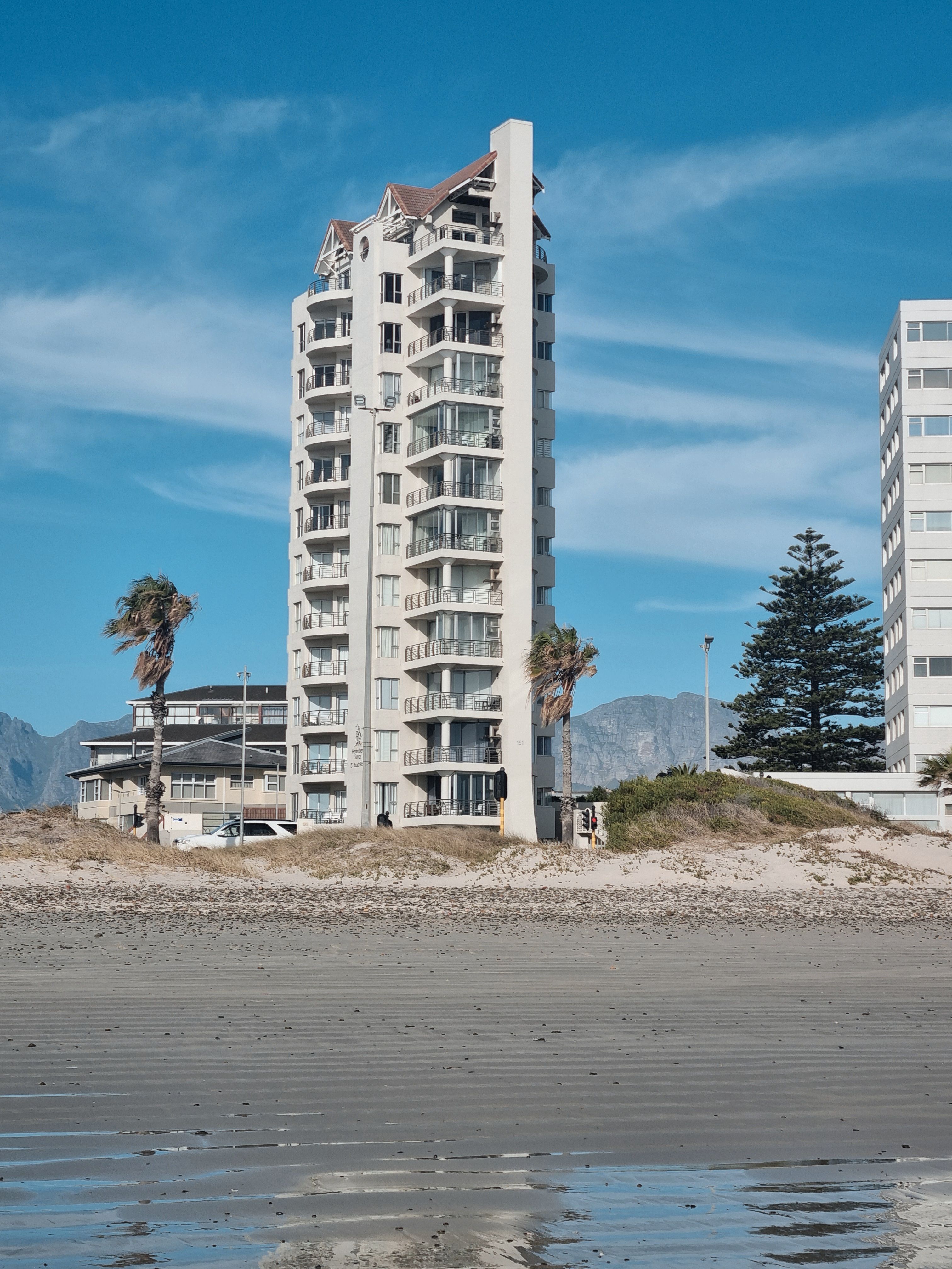 Coastal High-Rise Building with Blue Sky · Free Stock Photo