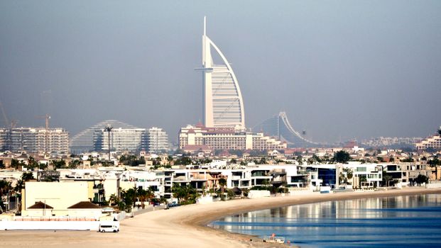 Stunning aerial view of Dubai's skyline featuring the Burj Al Arab and luxurious beachfront properties.