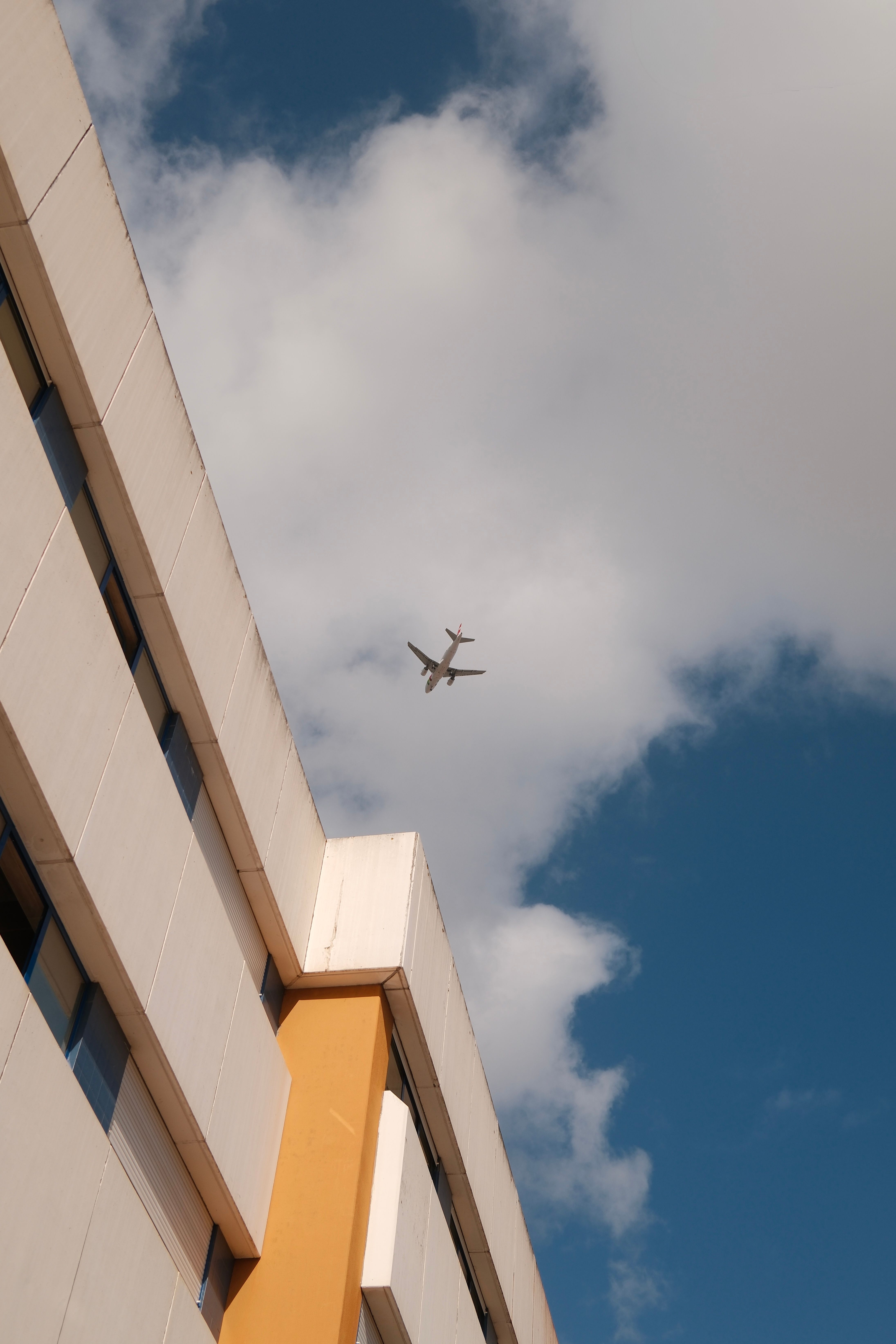 Airplane Above A Building · Free Stock Photo