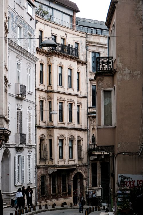 Free A picturesque scene of a historic alleyway in a European city, showcasing architectural details and urban charm. Stock Photo