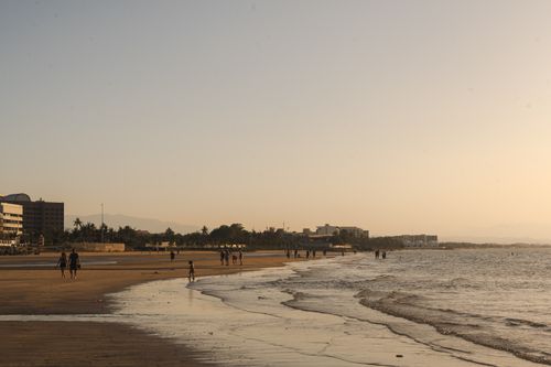 Free People enjoying a serene sunset at a beach in Muscat, Oman. Perfect for travel and nature themes. Stock Photo