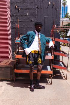 Man showcasing bold urban fashion against a vibrant Nairobi backdrop.