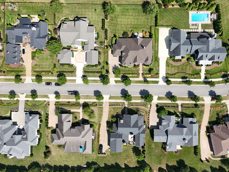 Aerial view of houses and tree-lined streets in an American suburban neighborhood