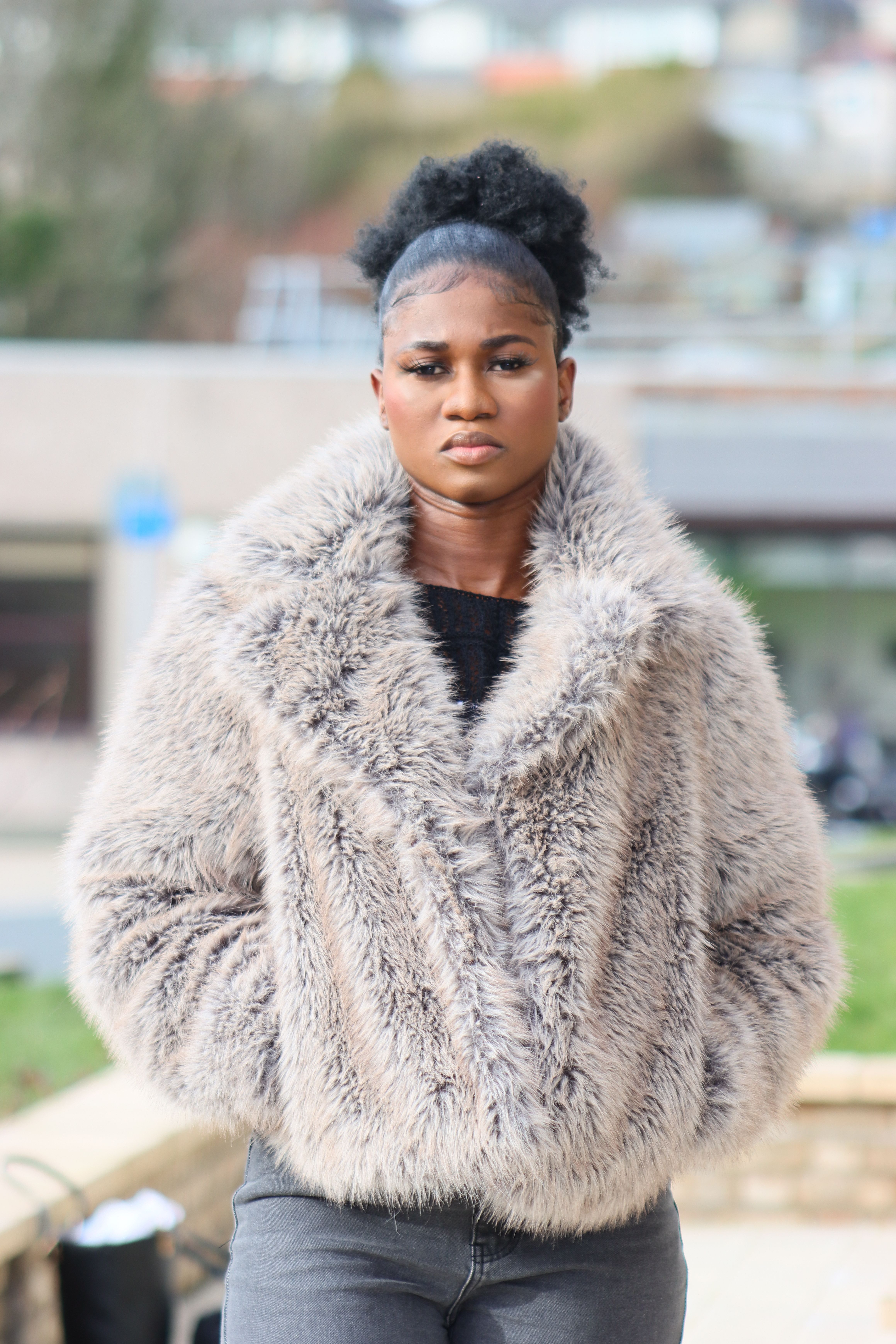 Young Woman in Fashionable Faux Fur Coat Outdoors · Free Stock Photo