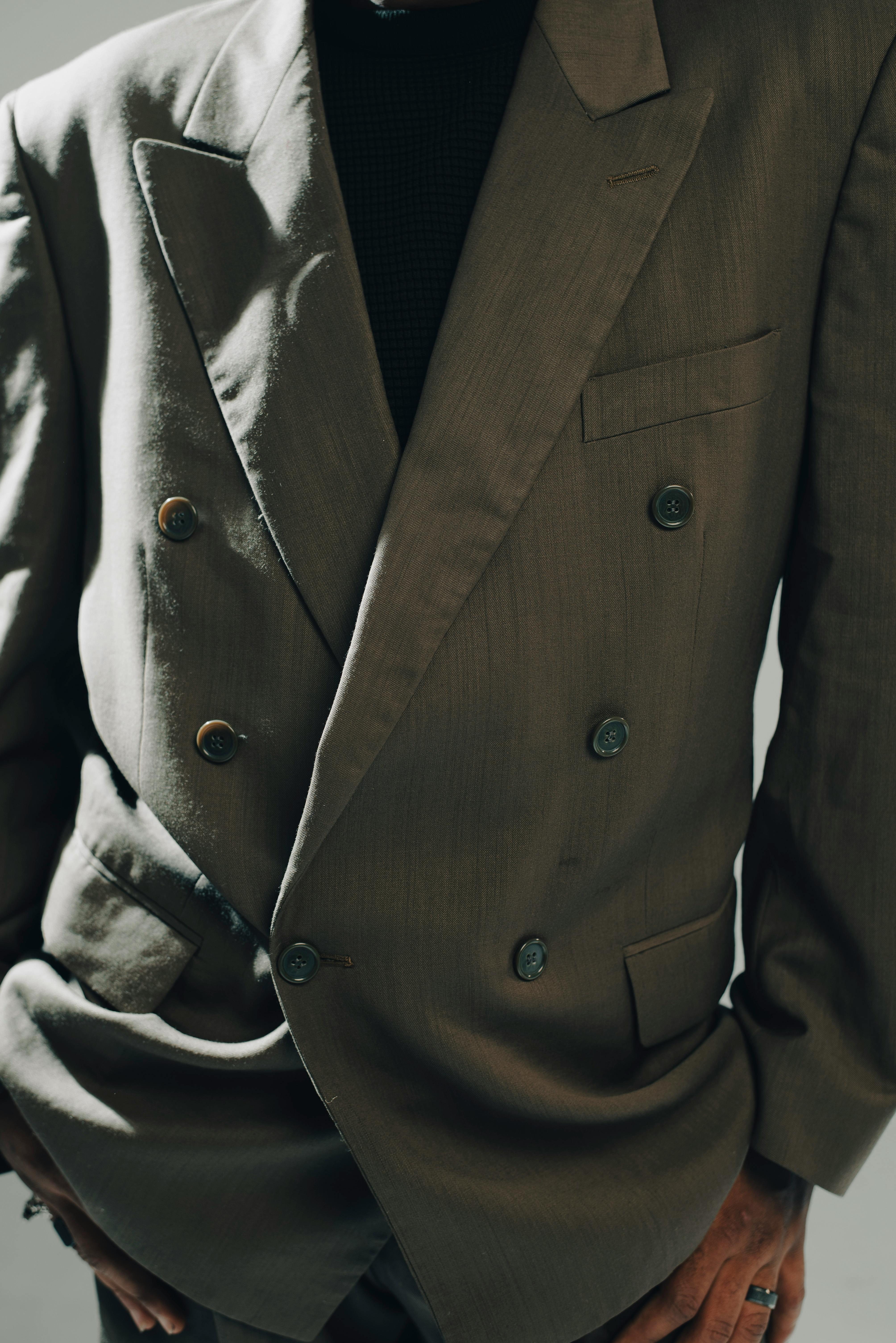 Free Close-up of a stylish double-breasted blazer with moody lighting. Stock Photo