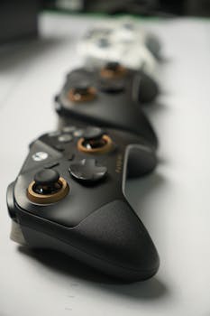 Black and white gaming controllers in a row with a blurred background, highlighting sleek design.