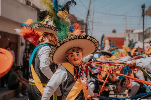 Free Energetic celebration features colorful costumes and dancers in Puebla, Mexico. Stock Photo