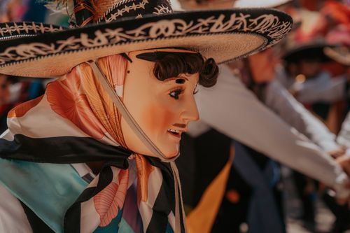 Free Close-up of a masked performer in traditional Mexican attire during a festival in Puebla, Mexico. Stock Photo
