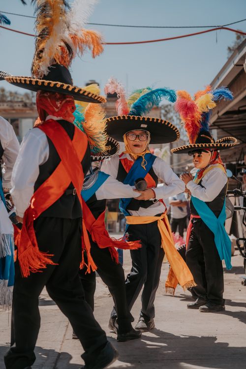 Free Colorful traditional dancers performing in Puebla, Mexico's vibrant street festival. Stock Photo
