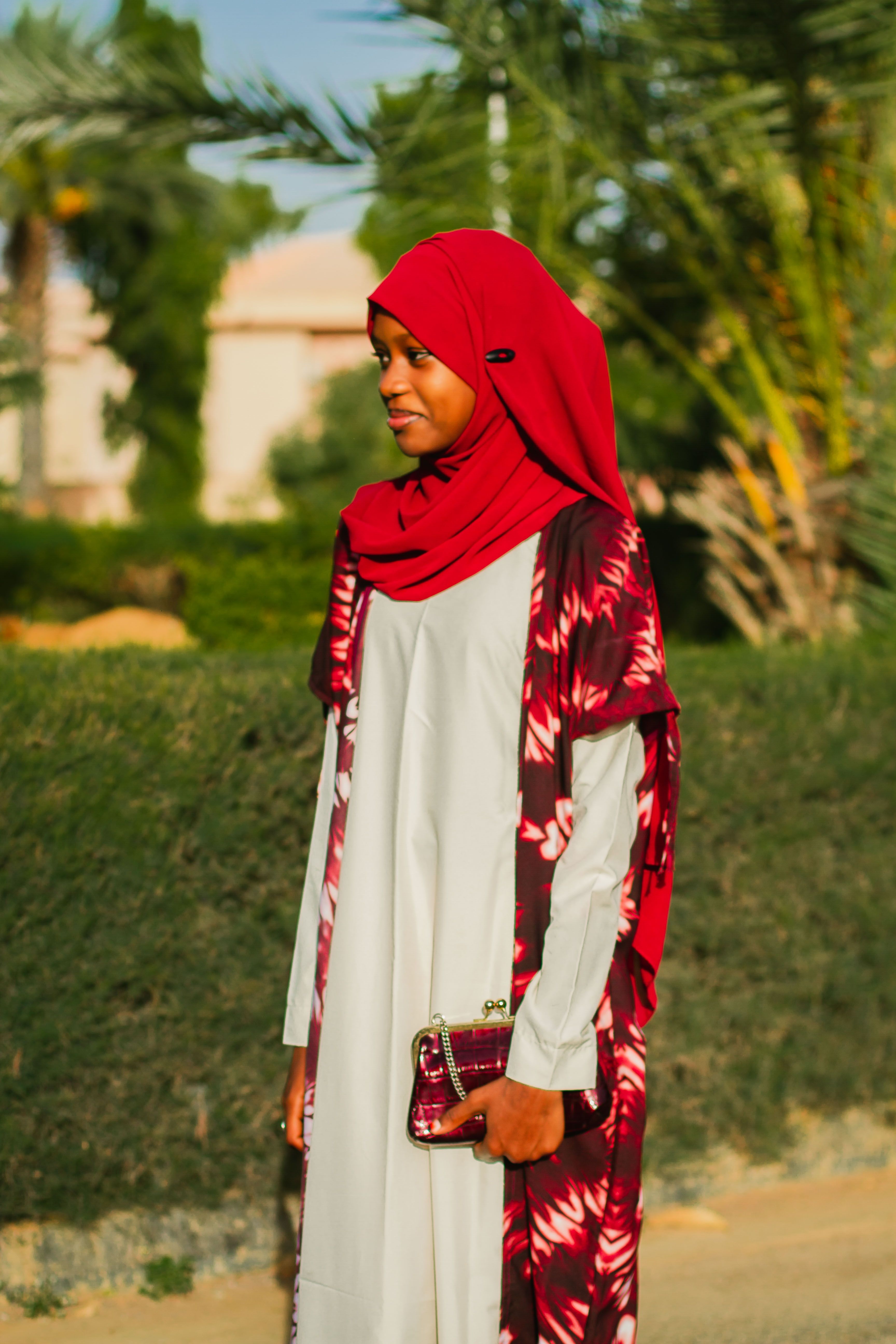 Woman in Red Hijab Smiling Outdoors · Free Stock Photo
