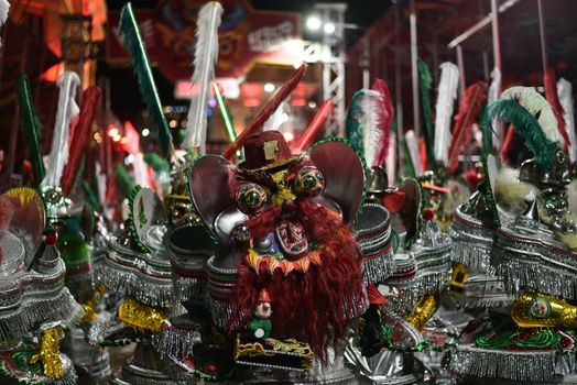 A display of vibrant traditional costumes at a Bolivian carnival, showcasing intricate designs and cultural heritage.