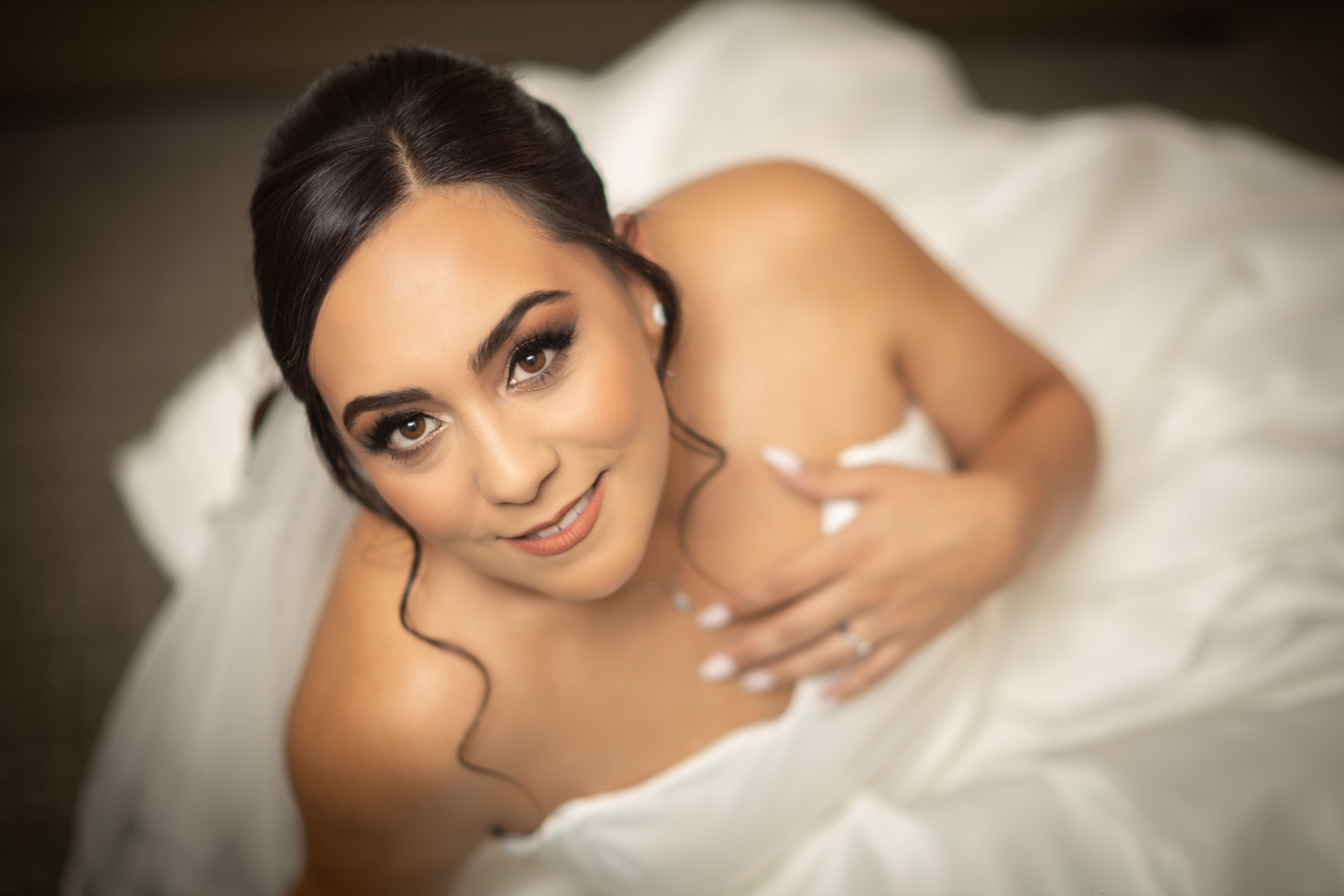 Stunning bridal portrait showcasing happiness and elegance in a classic wedding attire.
