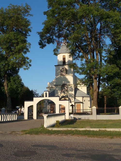 Free Beautiful church surrounded by trees in Dołhobrody, Poland during a sunny day. Stock Photo