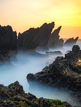 Capture of dramatic Sawarna rock formations against a vibrant sunset, Banten, Indonesia.