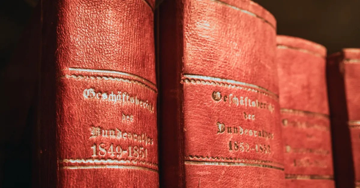 Rows of leather-bound legal volumes on a library shelf