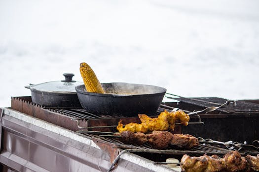 Outdoor grill scene with corn and chicken skewers, perfect for barbecue themes.