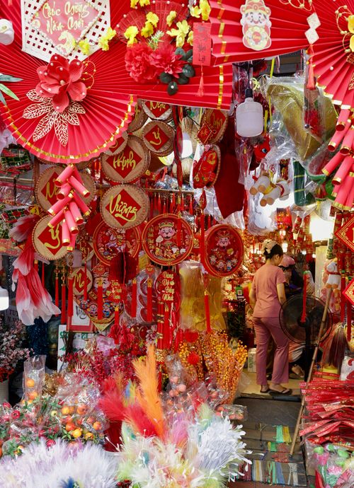 Free A bustling market stall featuring colorful Asian festival decorations, creating a lively and festive atmosphere. Stock Photo