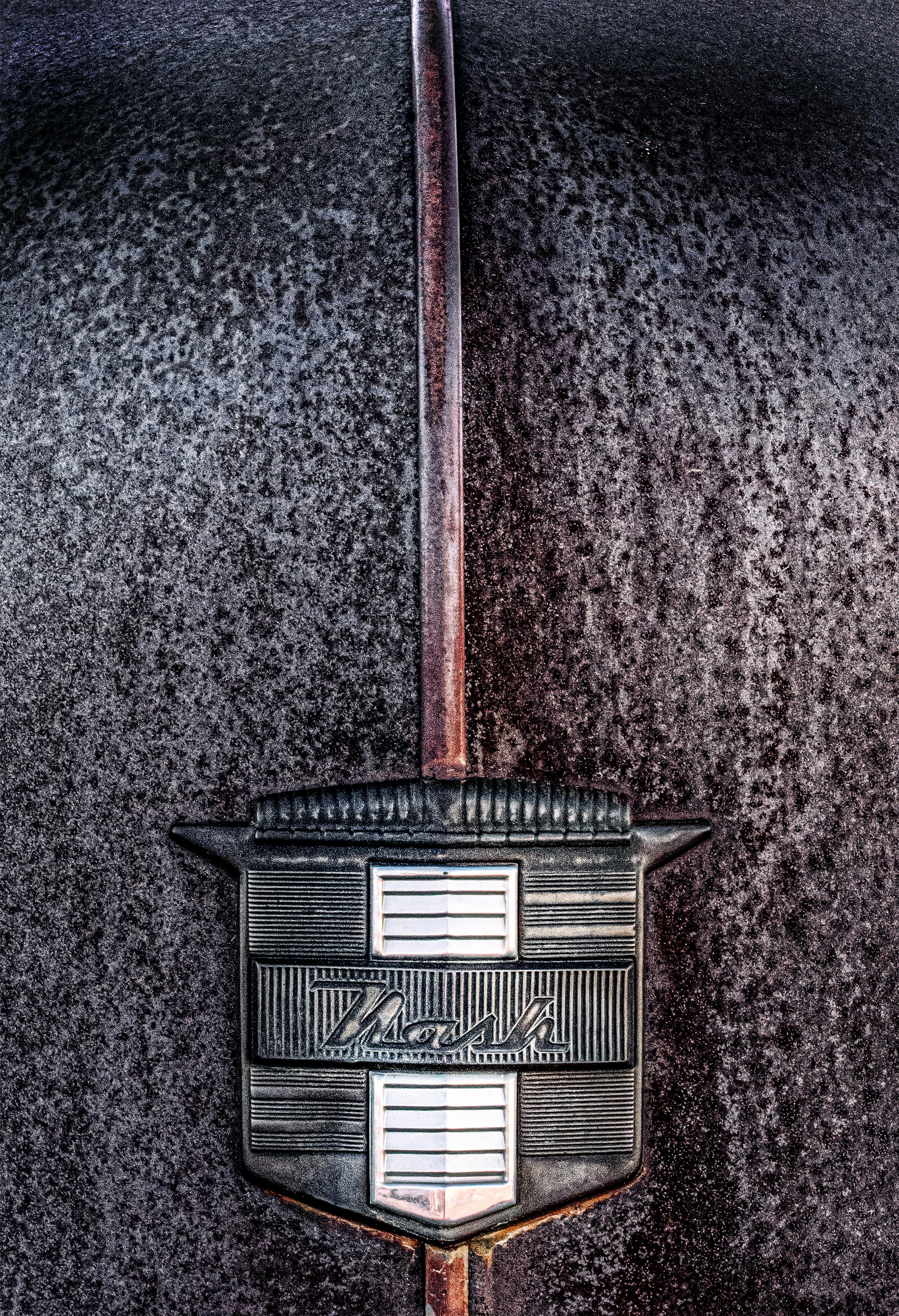 Free Close-up of a vintage Nash car emblem on a weathered hood, showcasing classic automotive decay in Nevada. Stock Photo