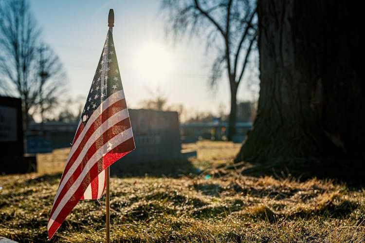 American Flag On Brown Grass Field