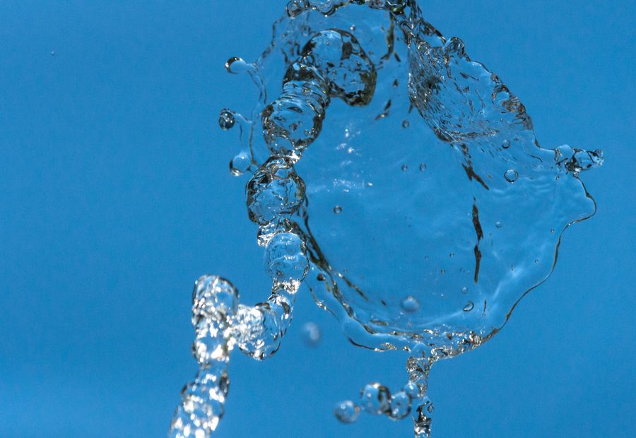 Clear water pouring against a blue background