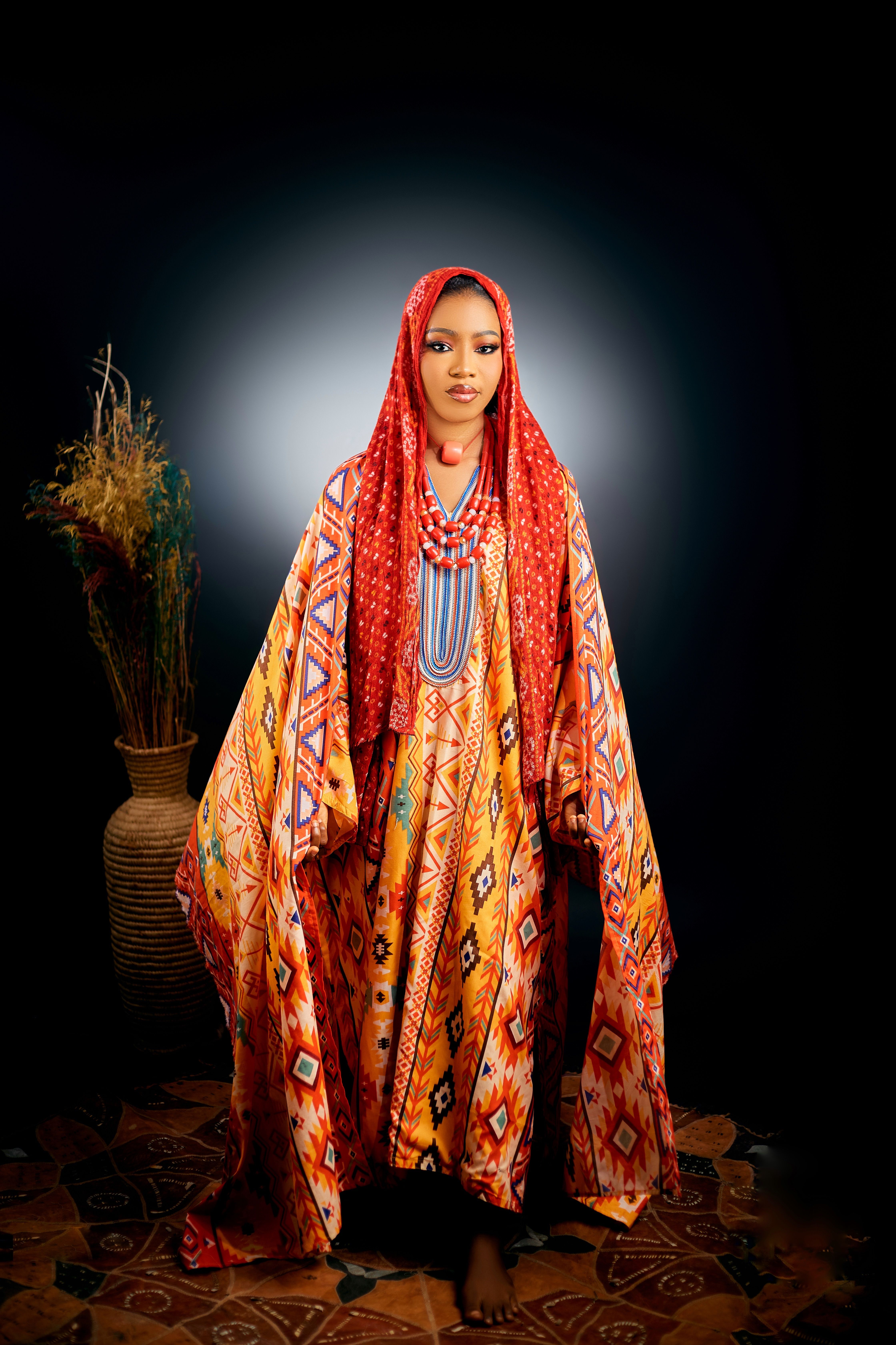 Vibrant portrait of a woman in traditional African attire with intricate patterns.