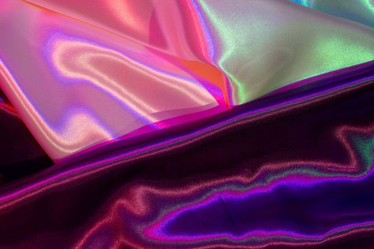 A captivating image of iridescent satin fabric showcasing vibrant gradient colors and luxurious texture.