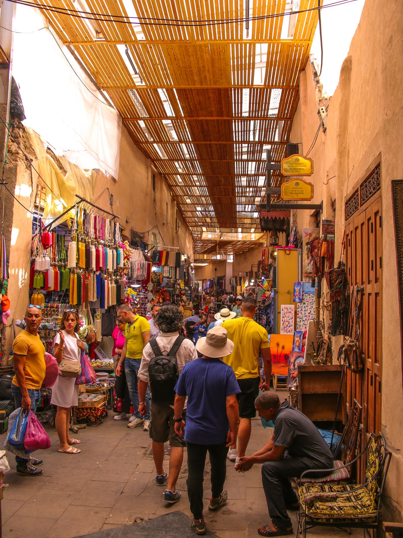 Busy street in the Marrakech medina with shops and passers-by