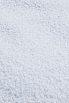 Close-up of snow texture providing a serene winter background.