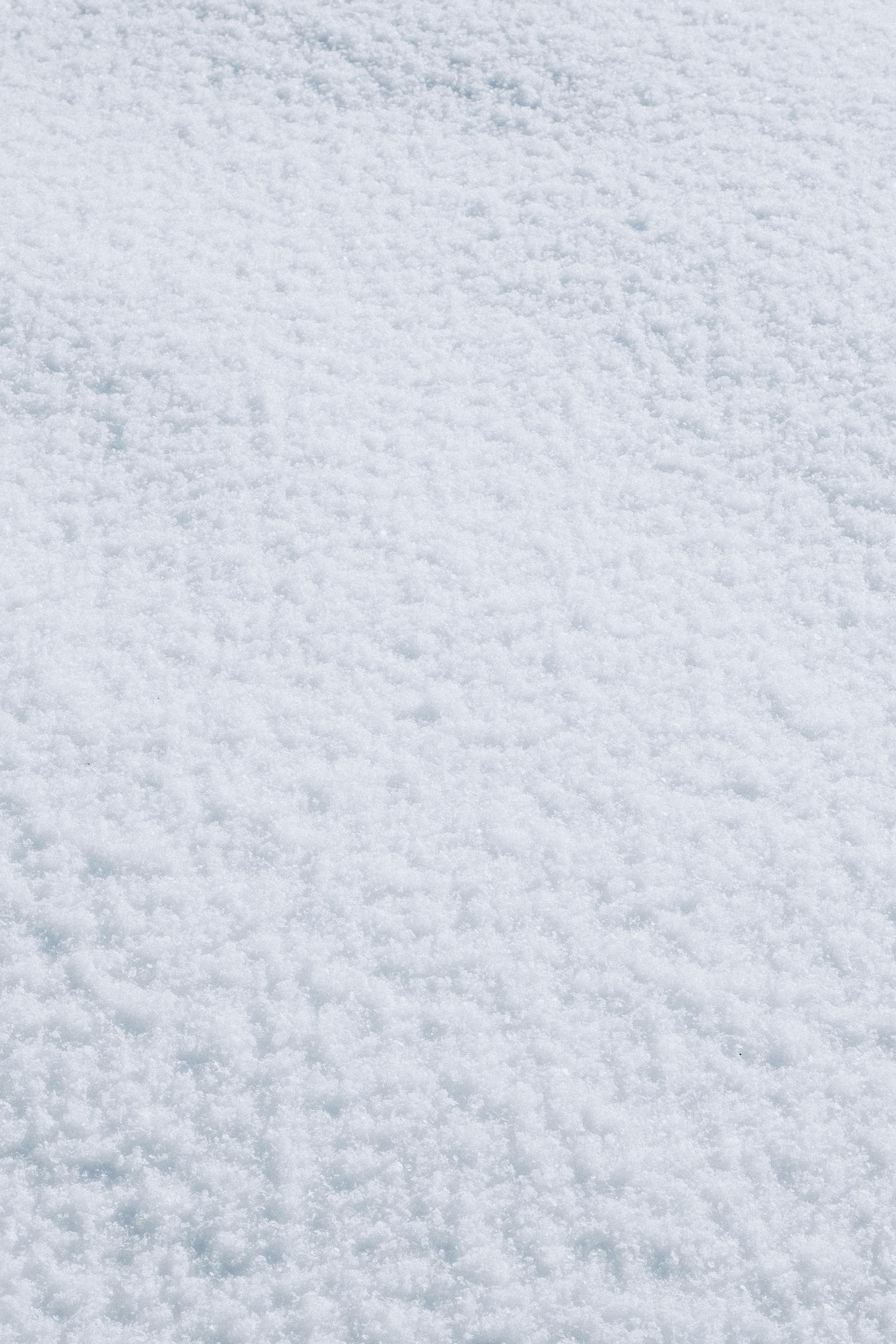 Free Close-up of snow texture providing a serene winter background. Stock Photo