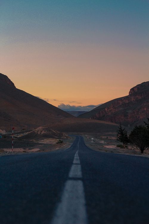 Free A picturesque winding road through the Atlas Mountains at sunset in Midelt, Morocco. Stock Photo