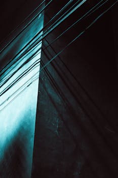 A dramatic view of shadow lines on a building facade creating an abstract geometric pattern.