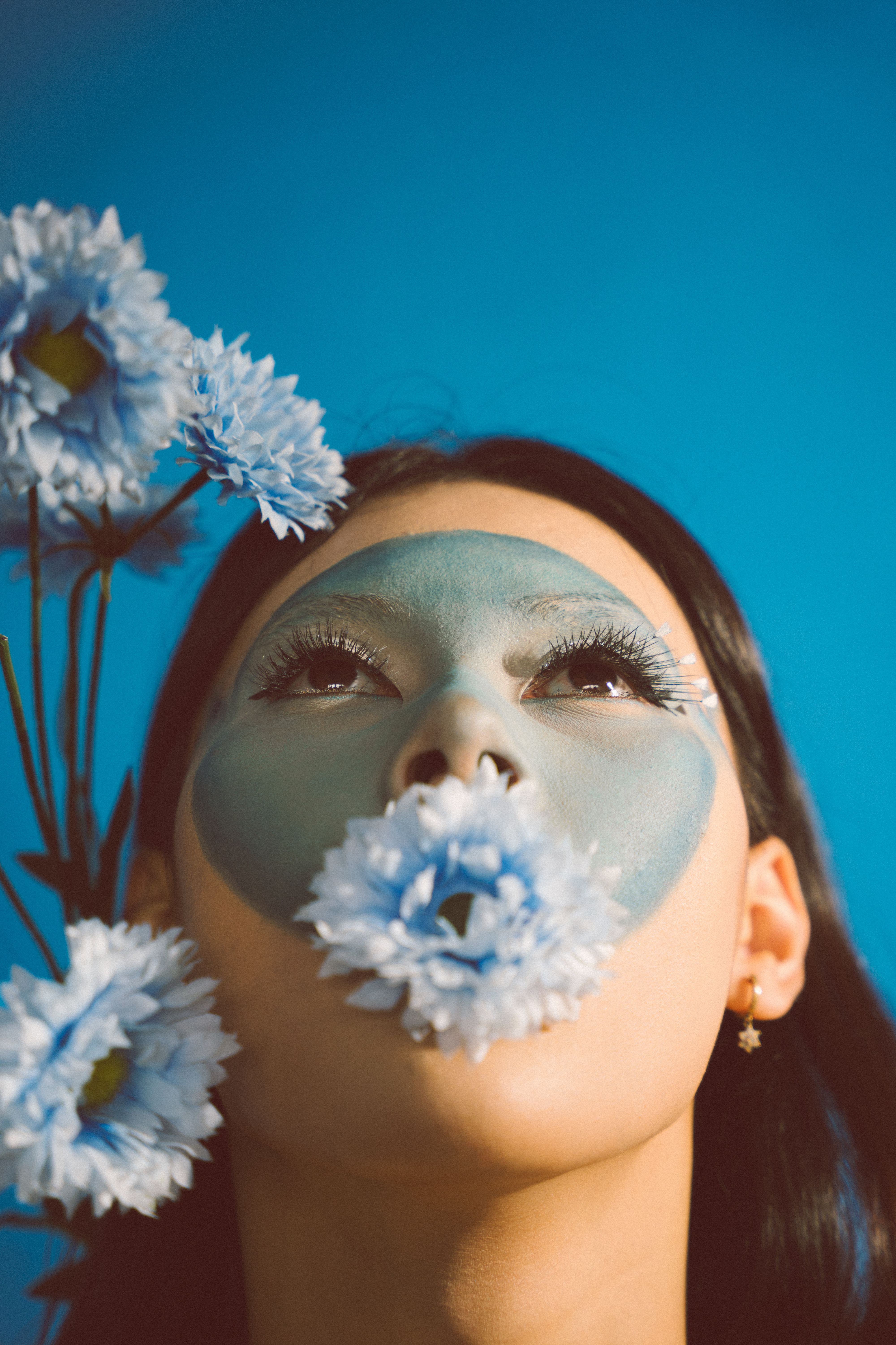 Creative Portrait with Flower and Blue Face Paint · Free Stock Photo