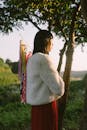 Woman with Fish Kites in Scenic Outdoor Setting