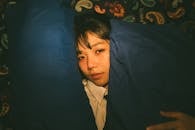 Portrait of Woman Relaxing with Pillows in Blue