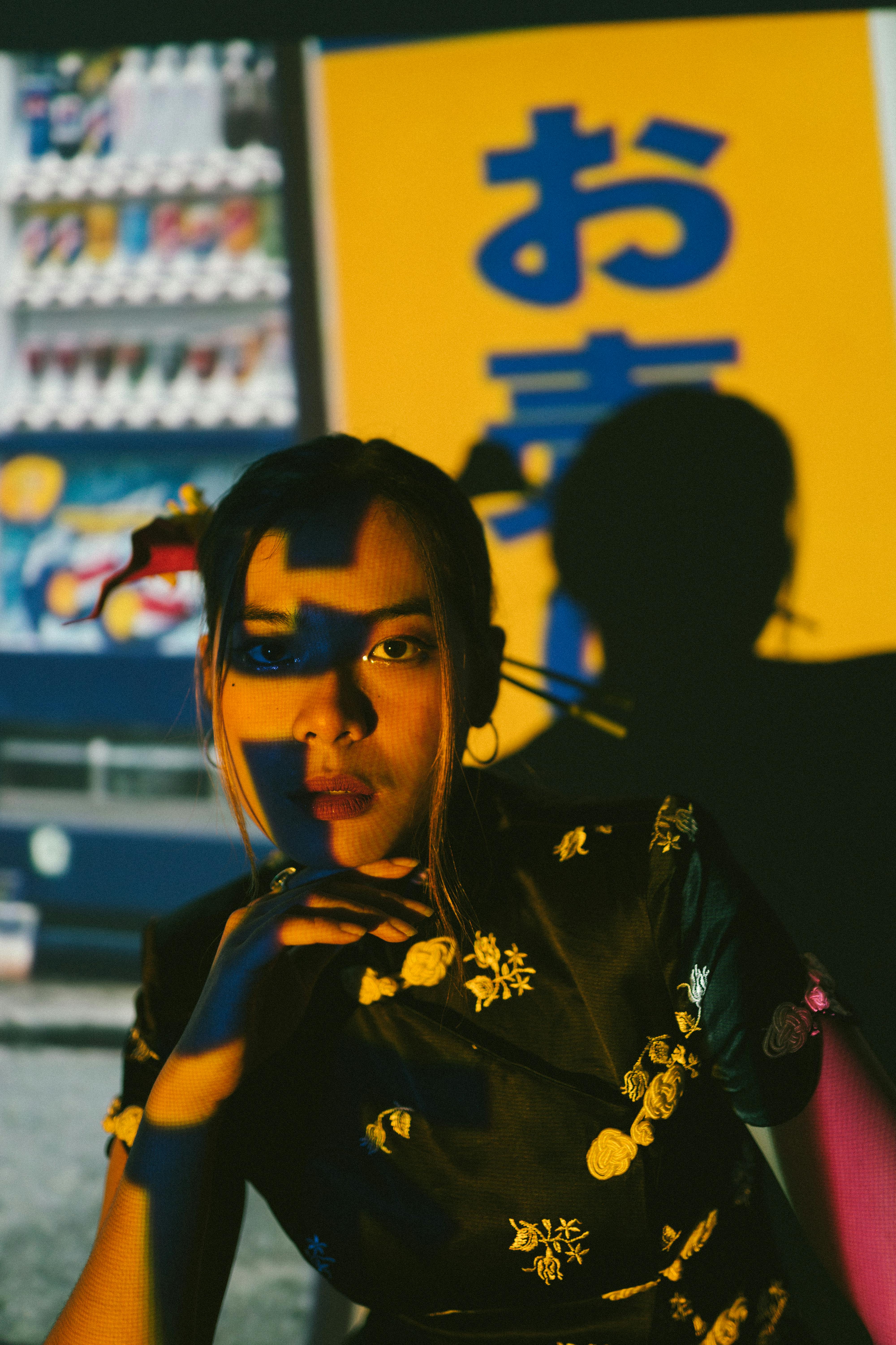 Artistic portrait of a woman with colorful shadow play and bold background.