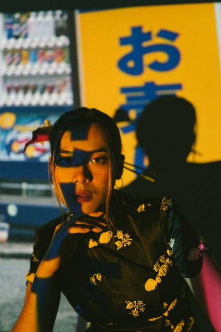 Artistic portrait of a woman with colorful shadow play and bold background.