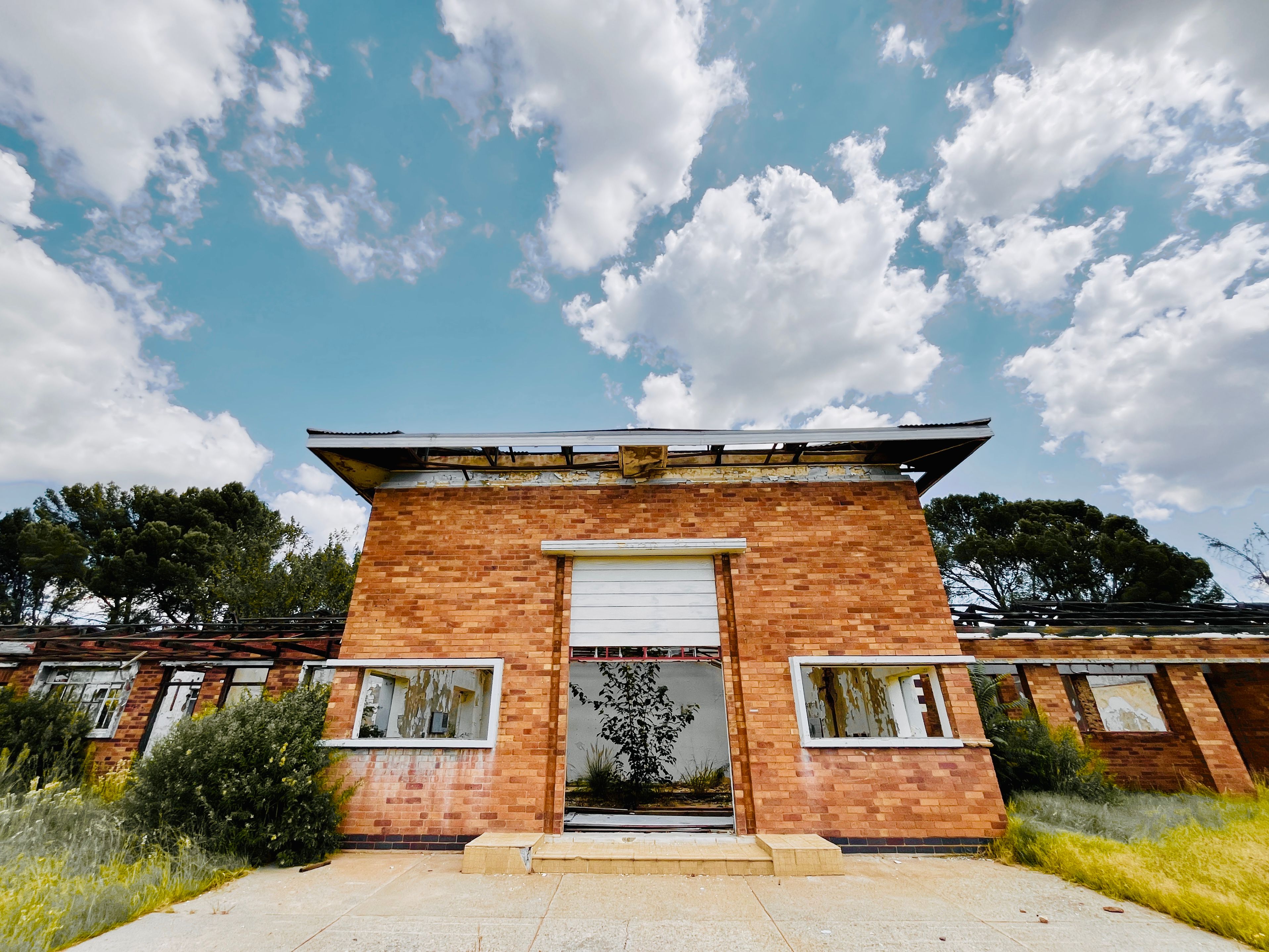 Abandoned Brick Building Under a Cloudy Sky · Free Stock Photo
