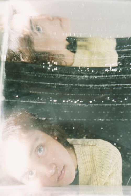 Free Explore a creative portrait of a person reflected in glass, evoking introspection and artistry. Stock Photo