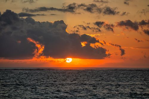 Free Captivating sunset over the ocean in Bali with dramatic clouds. Stock Photo