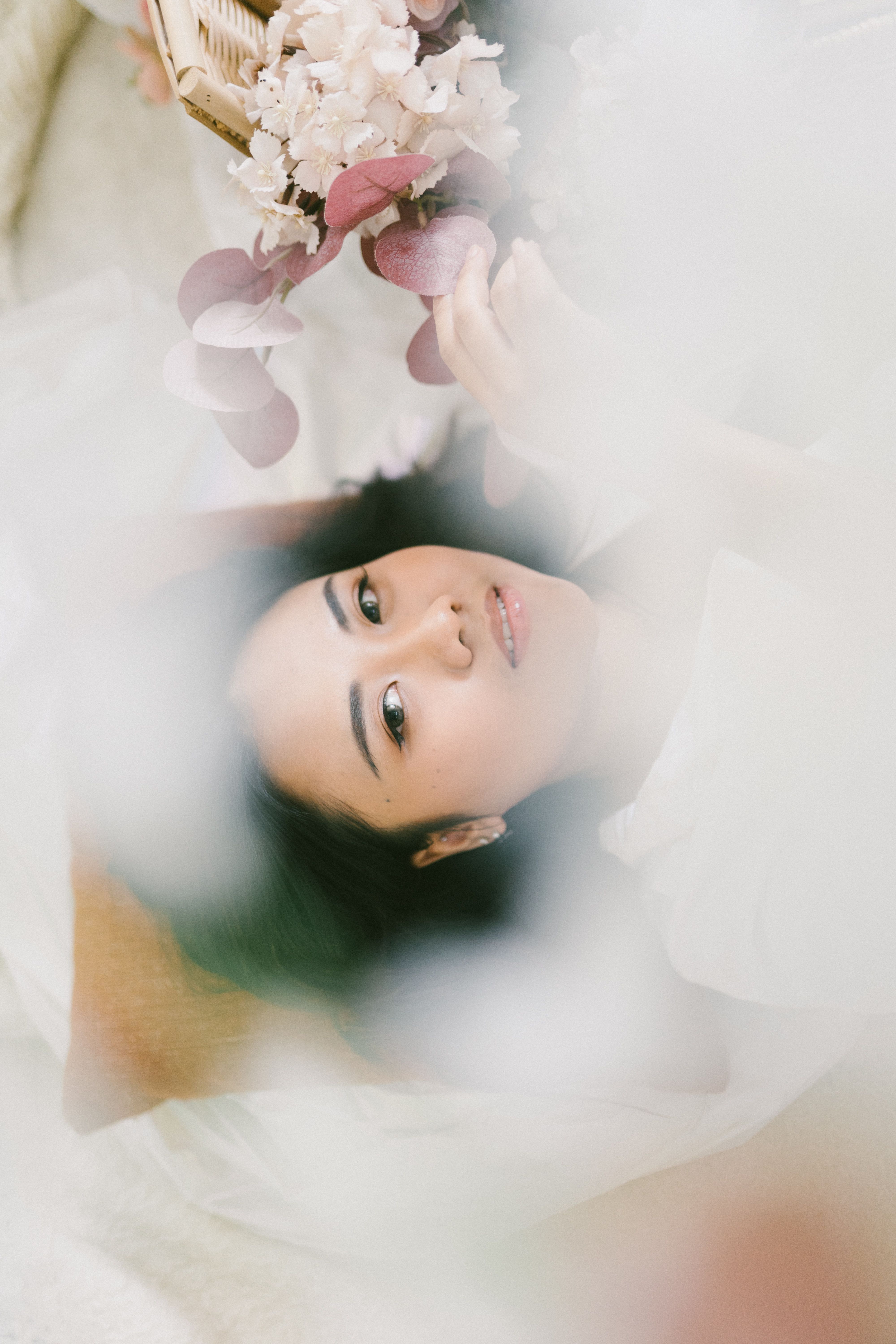 Serene portrait of a woman with delicate flowers, soft and dreamy style.