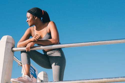 Woman in Black Tank Top and Gray Leggings 