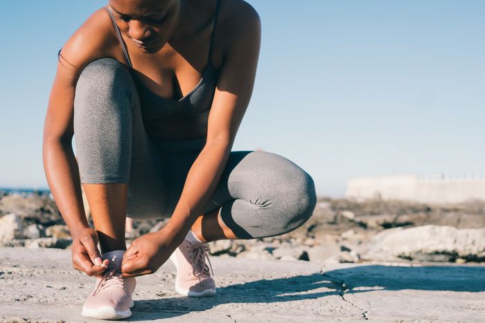 Woman stretching outdoors against a city backdrop