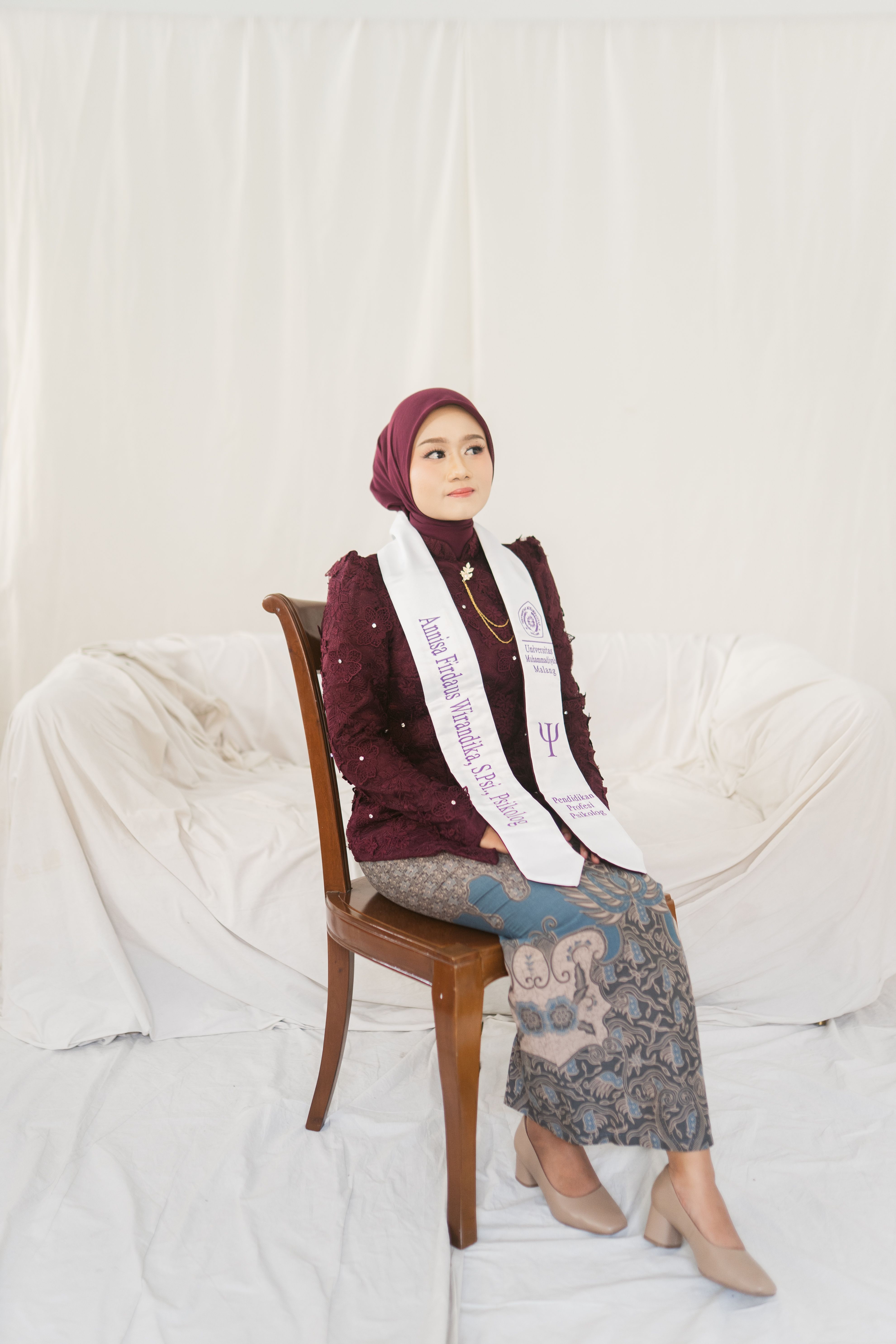Graduate in Hijab Posing in Traditional Attire